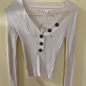 A A white long sleeve tight shirt with buttons